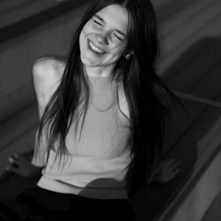 Aisha Raman, Lead Design Curator at Harbor Panel Studio, reviewing corporate floral arrangements